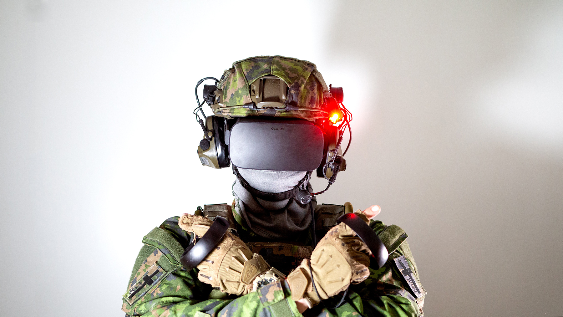 A person in military gear wears a VR headset.